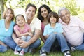 Multi Generation Hispanic Family Standing In Park