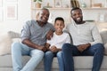 Multi generation male family members posing together at home Royalty Free Stock Photo
