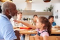 Multi-Generation Mixed Race Family Eating Meal Around Table At Home Together Royalty Free Stock Photo