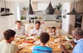 Multi-Generation Mixed Race Family Eating Meal Around Table At Home Together Royalty Free Stock Photo