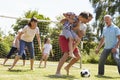 Multi Generation Playing Football In Garden Together Royalty Free Stock Photo
