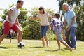 Multi Generation Playing Football In Garden Together Royalty Free Stock Photo