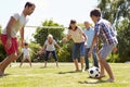 Multi Generation Playing Football In Garden Together Royalty Free Stock Photo