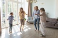 Multi-generational family dancing in sunny cozy living room Royalty Free Stock Photo