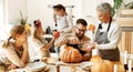 Multi generational family making jack o lantern