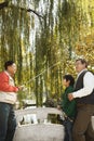 Multi-generational men fishing at lake Royalty Free Stock Photo