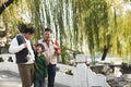 Multi-generational men walking with fishing gear at lake Royalty Free Stock Photo