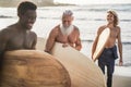 Multi generational surfer men having fun on the beach - Main focus on senior face