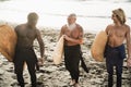 Multi generational surfer men having fun on the beach - Main focus on senior face