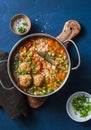 Multi grain, meatballs and vegetables soup in a pot on a blue background, top view. Comfort home cooking healthy seasonal food Royalty Free Stock Photo