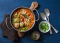 Multi grain, meatballs and vegetables soup in a pot on a blue background, top view. Comfort home cooking healthy seasonal food Royalty Free Stock Photo