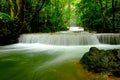 Multi-layered water fall with one rock in front of it in the forest of national park, Thailand Royalty Free Stock Photo