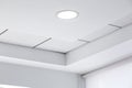 Multi-level ceiling with three-dimensional protrusions and a suspended tiled ceiling.