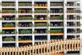 Multi level parking garage decorated with green plants with many cars parked. Royalty Free Stock Photo