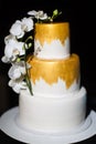 Multi level wedding cake with with white orchids Royalty Free Stock Photo