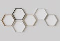 Multi material hexagon blank photo frames mockup hanging on interior wall. Hexagonal pictures on painted surface. 3D rendering Royalty Free Stock Photo