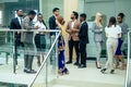 Multi Nationality of business people : indian, korean, afro-american and caucasian stand on the stairs in a modern