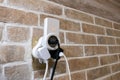 Multi-plug adapter with chargers connected, providing power against a brick wall. A red indicator light shows activity, Royalty Free Stock Photo