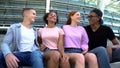 Multi-racial group young people hugging sitting outdoors friendship togetherness Royalty Free Stock Photo