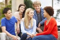 Multi racial student group sitting outdoors Royalty Free Stock Photo