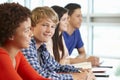 Multi racial teenage pupils in class, one smiling to camera Royalty Free Stock Photo