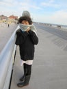 Multi Racial tween girl on boardwalk on beach Royalty Free Stock Photo