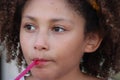 Multi Racial tween girl close up eating red ices Royalty Free Stock Photo