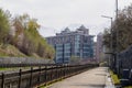 Multi-storey apartment buildings of an elite residential complex above the river embankment, walking area on a spring day Royalty Free Stock Photo