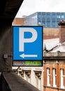 Multi storey car park P sign blue with bright green neon writing showing spaces and arrow. Royalty Free Stock Photo