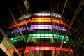 Multi-storey glass building illuminated with colored lights at night Royalty Free Stock Photo