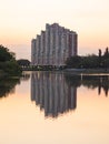 multi-storey house on the shore of the lake real and reflection evening Royalty Free Stock Photo