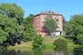 Multi-storey house standing in green trees near river. Nature in city Royalty Free Stock Photo