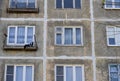 A multi-storey residential building of the Soviet period. Gray faceless windows and walls. Russia.