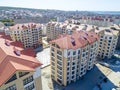 The multi-storey residential micro district consisting of several buildings. Red roof.