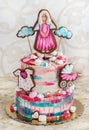 A multi-tier cake for baptism for a girl with gingerbread Royalty Free Stock Photo