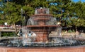 Multi-tiered musical `Singing` fountain. Pool and bowls of fountain are made of red granite. Royalty Free Stock Photo