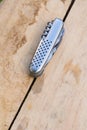 Multi-tool pocket knife on weathered wooden surface in outdoor setting Royalty Free Stock Photo