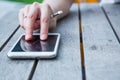 Multi touch smartphone on woodden table Royalty Free Stock Photo