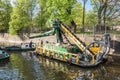 The multibucket dredger is working on cleaning the bottom of the canal in Kronstadt from bottom debris