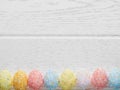 Multicolor artificial eggs on white background. Copy space. Happy Easter concept.