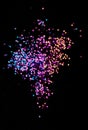 Multicolor bokeh lights, tiny hearts on a black background, top view, carnival, night party invitation or festive