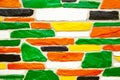 Multicolor brick wall in green and yellow and orange colors