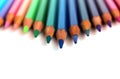Bright color pencils horizontal wave on white background with blue central pencil on focus Royalty Free Stock Photo
