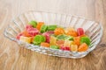 Multicolor dried pineapples in transparent bowl on table