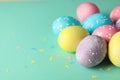 Multicolor Easter eggs on mint background Royalty Free Stock Photo