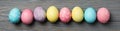 Multicolor Easter eggs on wooden background, space for text Royalty Free Stock Photo