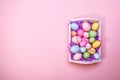 Multicolor eggs in a white tray. Creative Easter concept. Modern