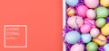 Multicolor eggs in a white tray. Creative Easter concept. Modern solid pink background. . Living coral theme - color of the year Royalty Free Stock Photo