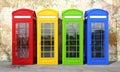 Multicolor english telephone booth on brick wall background Royalty Free Stock Photo