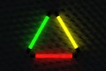 Multicolor fluorescent lamps on a dark wall. Electric tube of neon color. Abstract background